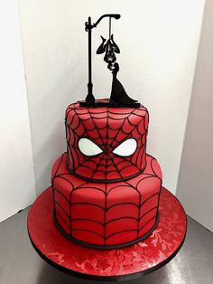 a spiderman themed cake on a red plate