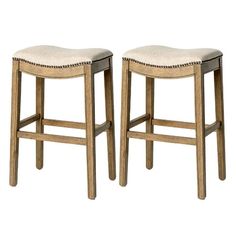 two wooden stools with beige upholstered seats