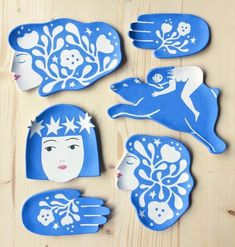 some blue and white paper cut outs on a wooden table