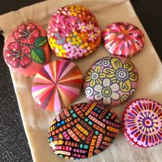 several colorfully painted rocks sitting on top of a table