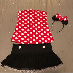 a minnie mouse outfit and headband on a bed