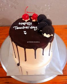 a birthday cake with chocolate icing and oreo cookies on the top that says happy teacher's day