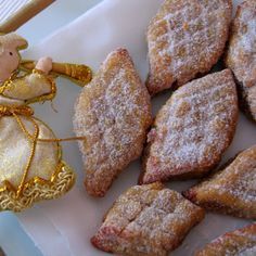 powdered sugar cookies with a little angel figurine next to it on a plate