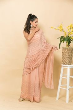 This peach crepe saree features intricate Mukaish embroidery and small pearl design for a stunning look perfect for parties and weddings. Its luxurious feel and gorgeous design make it a timeless piece that you'll never tire of wearing. Traditional Peach Pre-draped Saree With Zari Work, Elegant Peach Georgette Lehenga, Peach Saree With Dupatta For Reception, Peach Traditional Wear For Reception With Traditional Drape, Peach Wedding Saree With Pallu, Peach Traditional Wear For Reception, Traditional Drape Peach Wear For Reception, Peach Traditional Drape For Reception, Traditional Peach Wear With Zari Work In Traditional Drape