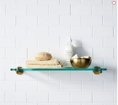 a shelf that has some towels on it and a bowl next to it with a lot of soap