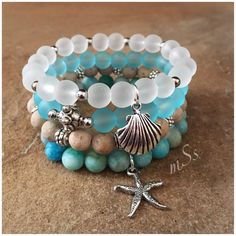 "Electic, boho chic stretch bracelet stack of four featuring 8mm beads of blue and white beach glass, matte beige and blue mix agate with silver tone accents, spacer beads and 2 beach-inspired charms.  One is a sea shell and the other a starfish. Versatile. Wear all or one at a time and pair with your other jewelry.  Stretch Bracelets Sized for a 7 \" wrist  mSs Distinctive Designs Studio Home Page: http://www.etsy.com/shop/mSsDDesigns  CUSTOM ORDERS ARE WELCOME I have access to a variety of gem Beach Themed Beaded Bracelets, Sea Inspired Bracelets, Beach Theme Jewelry, Blue Gemstone Bracelet, Memory Wire Jewelry, Organizing Hair Accessories, Bracelets Beaded, Studio Home, Beige And Blue