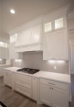 a kitchen with white cabinets and an oven