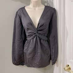 Never Worn Pleione Gray Satiny Top With Long Sleeves, Elastic Wrists, Elastic Peplum Waist In The Back, And Twisted Front Neckline. Size Medium. Gray V-neck Blouse For Work, Gray V-neck Blouse For Workwear, Gray Long Sleeve Tops With Button Closure, Chic Gray V-neck Blouse, Gray Slim Fit Button-up Top, Gray V-neck Tops With Button Closure, Crossover Top, Crossover, Elastic