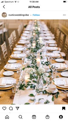 a long table is set with white plates and place settings for an elegant dinner party