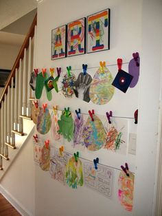 the wall is decorated with paper cutouts and pictures hanging on it's sides