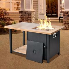 a fire pit sitting on top of a wooden table