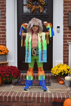 a man dressed in colorful clothing standing on steps