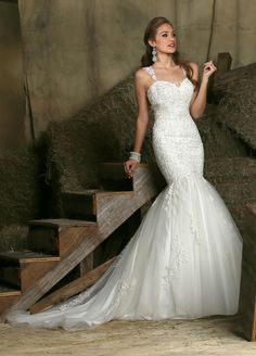 a woman in a wedding dress posing for the camera