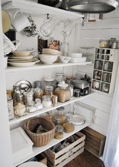 the shelves in this kitchen are filled with dishes