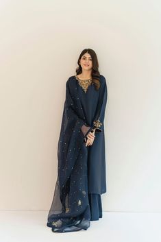 This beautiful three piece is designed on dark navy blue pure raw silk 60 gms with intricate detailed gold hand/ada work, styled with a embellished dupatta featuring wild floral motifs. An head turner design for your festive events. Order Duration: 4 to 6 weeks Navy Blue Pakistani Dress, Navy Blue Salwar Suit, Blue Pakistani Dress, Salwar Design, Raw Silk Dress, Blue Colour Dress, Dark Blue Suit, Navy Blue Design, Punjabi Salwar