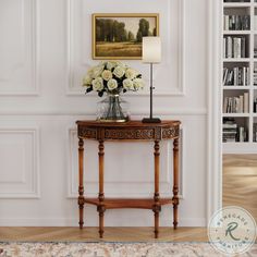 a table with flowers on it in front of a bookshelf