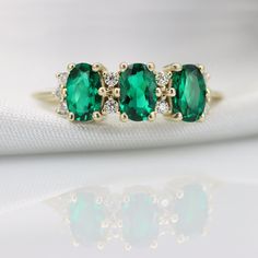 "Handmade by an inspired jewelry artist team with decades of experience in the craft of jewelry making. Each gemstone, each diamond is carefully picked. Using only the finest raw materials and the highest industry standard in manufacturing, design and finish. A beautiful vintage inspired piece handmade just for you. Perfect Emerald and diamonds ring flaunting 3 beautifully contrasting emeralds and ten super clean white diamonds full of sparkle and fire. Ring Features *Emerald info: Three 6x4mm o Ring Gold Diamond, Fire Ring, Green Emerald Ring, Jewelry Artist, Diamonds Ring, Three Stone Engagement, Three Stone Engagement Rings, Ring Oval, Inspired Jewelry