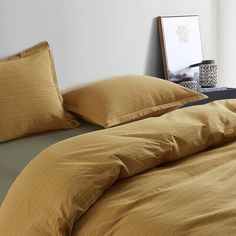 a bed with yellow and brown striped sheets