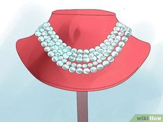 a red hat with two rows of pearls on it and a necklace hanging from the front