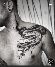 a man's chest with a dragon tattoo on his chest and the head of a snake