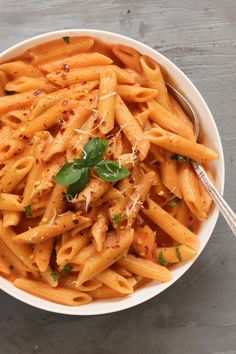 a white bowl filled with pasta and sauce