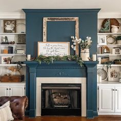 a living room filled with furniture and a fire place under a painting on the wall