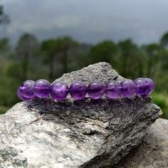 Discover the beauty and power of our handmade, adjustable Amethyst Macrame bracelet, designed to fit both men and women perfectly. Crafted with intention, this bracelet features Amethyst crystals, believed to be a powerful stone that provides protection, stress relief, and spiritual growth. As the February birthstone, it makes a meaningful gift for a loved one or a special treat for yourself! '¨) ¸.*'¸.*'¨) ¸. (¸.*' (¸.*` ♥ *FREE INTERNATIONAL SHIPPING ►► Use the drop-down menu to select your preferred option:  ► 6mm Beads Bracelet ► 8mm Beads Bracelet ►► Thanks to the drawstring closure, the bracelet's circumference adjusts from a minimum of 7.5'' (20cm) to a maximum of 10.5'' (27cm). ►►The wax black cord is 100% vegan, durable, and safe for showering and swimming. ►► Each bracelet featur Amethyst Beaded Bracelet For Meditation, Spiritual Amethyst Bracelets With Gemstone Beads, Spiritual Amethyst Bracelet With Gemstone Beads, Spiritual Amethyst Bracelet With 8mm Beads, Spiritual Amethyst Crystal Bracelet With 8mm Beads, Purple Bracelets With 8mm Beads As Gift, Purple 8mm Beads Bracelets As Gift, Spiritual Amethyst Gemstone Beads Bracelet, Healing Amethyst Beaded Bracelets