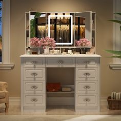 a dressing table with flowers and a mirror