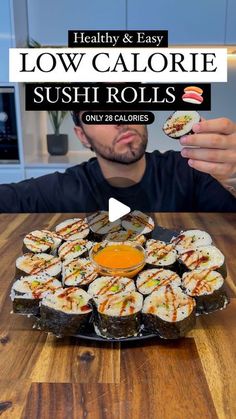 the man is eating sushi rolls on his plate with an orange sauce in front of him