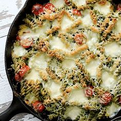 a pan filled with pasta and sauce on top of a wooden table next to an instagram page