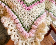 a crocheted blanket sitting on top of a wooden chair