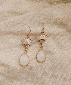 Our Aria Moonstone Earrings are simply beautiful. Made with genuine rainbow moonstone, they're made to stand out. They were designed for the classic, yet bohemian chic bride who wants a dainty look on her wedding day.FEATURES Genuine Rainbow Moonstone Teardrop set in gold vermeil or sterling silver Choice of Materials: 16k gold, rose gold, or sterling silver Ear wire is sterling silver or gold filled 100% nickel free, great for sensitive ears Delicate Gemstone Earrings For Wedding, Bohemian Dangle Crystal Earrings For Wedding, Elegant Wedding Moonstone Earrings, Elegant Moonstone Dangle Crystal Earrings, Elegant Gold Crystal Earrings With Moonstone, Bohemian Crystal Drop Earrings For Wedding, Elegant Moonstone Jewelry With Pearl Drop, Gemstone Dangle Teardrop Earrings For Wedding, Elegant Moonstone Teardrop Earrings