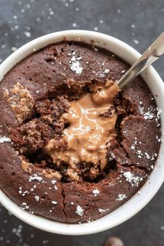 a bowl filled with brownie and ice cream on top of a black countertop