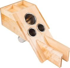 a wooden object that looks like a rocket ship with four holes in the bottom and one hole at the top