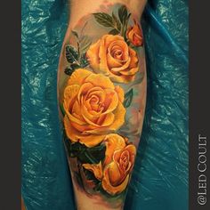 a yellow rose tattoo on the leg