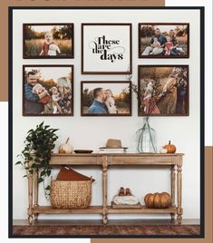 a wooden table topped with pictures next to a wall filled with plants and pumpkins