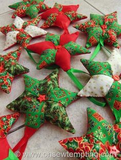 several green and red bows are laying on the floor next to each other, all decorated in different designs