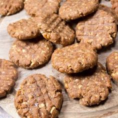 several cookies are arranged on a wooden platter, ready to be eaten and served