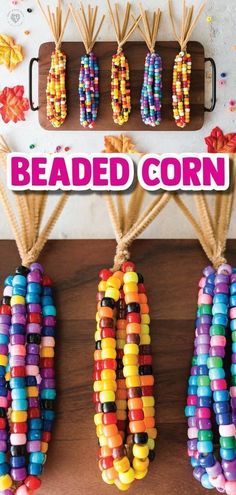 colorful beaded corn hanging from hooks on a wooden table with text overlay reading beaded corn