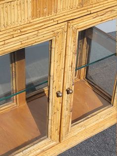 an old bamboo display case with glass doors