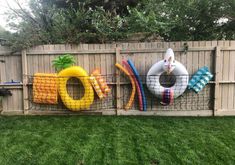 an inflatable pool float is on display behind a fence