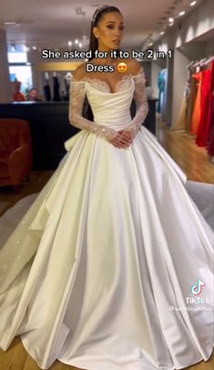 a woman wearing a white wedding dress in a store