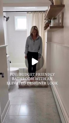 a woman standing in a bathroom with the words pov budget friendly bathroom with an elevated designer look