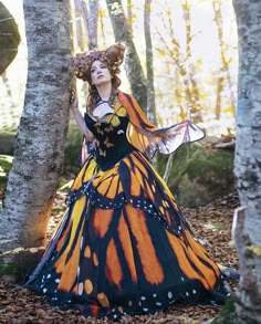 a woman dressed as a butterfly in the woods