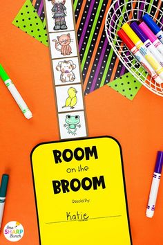 a room on the broom book with markers, pens and crayons next to it