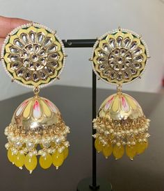 Yellow Meenakari Kundan Jhumka earrings. Ethnic Stylish Trendy Look. The Look is Stunning and Preciously Suitable for all Kinds of Occasions. Length: 4 inch Width: 1.5 inch Handcrafted pair of earrings. Gives a traditional look. Indulge in it or gift it and watch the compliments flow! It is advisable to store jewelry in a zip lock pouch (air tight pouch), keep away from water perfume and other chemicals and clean it with soft cloth. FREE SHIPPING!! Yellow Jhumka, Desi Jhumka, Kundan Jhumka Earrings, Kundan Jhumka, Punjabi Jewelry, Pakistani Earrings, Earrings Kundan, Water Perfume, Store Jewelry