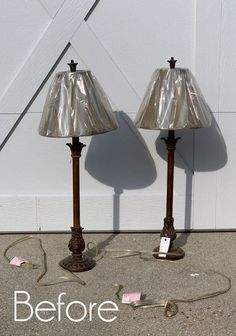 two lamps that are sitting on the ground next to each other, one has a price tag in front of it