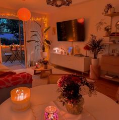 a living room filled with furniture and a flat screen tv mounted to the side of a wall