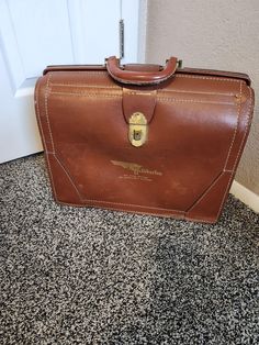 IF YOU ARE INTERESTED IN A LOWER SHIPPING RATE PLEASE OPT FOR ADVANTAGE GROUND WHICH USUALLY TAKES ABOUT 2 DAYS LONGER THAN PRIORITY. IF IT DOESN'T SHOW UP AT CHECKOUT PLEASE CONTACT ME. Mid Century Split Cowhide Leather Top Open Halliburton Briefcase Good Vintage Condition. External Scrapes. Bottom Corner Of One Side In Rough Shape. Interior Good Condition And Fairly Clean. Interior PieceOf Leather Has Come Unglued . See Photos Previous Owner's Name Stamped On Front. Hallibuton And Six Years Driving , No Chargeable Accident  Reddish Brown With White Top Stitching Gold Brass Latch Leather Handle Weight 4 Lbs 8 Oz 12" High 16" Wide 6" Deep Vintage Rectangular Business Case, Vintage Formal Briefcase With Luggage Sleeve, Vintage Business Cases With Leather Lining, Retro Brown Briefcase For Formal Use, Vintage Brown School Bags, Vintage Brown Business Bags, Retro Rectangular Business Briefcase, Vintage Brown Bags For Business, Vintage Rectangular Business Briefcase