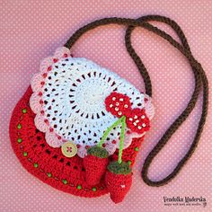 a crocheted purse with strawberries on it